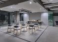 Modern conference room with EliteProAV commercial projector screen and seating.
